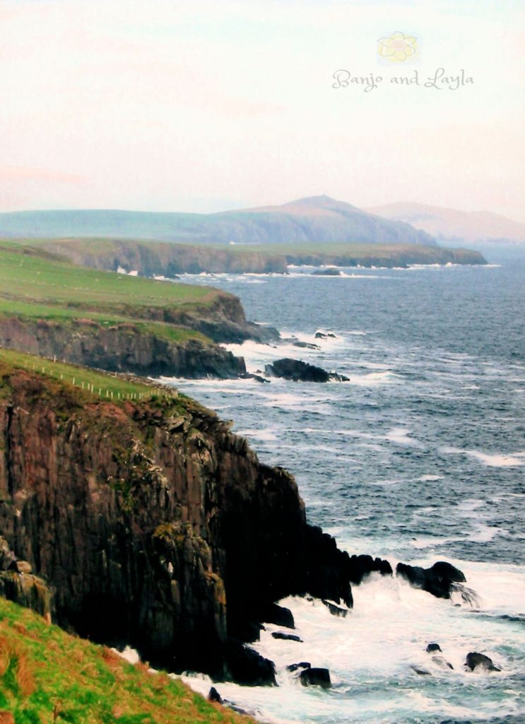 Waves along rocky cliffs by the Ring of Kerry in Ireland. 