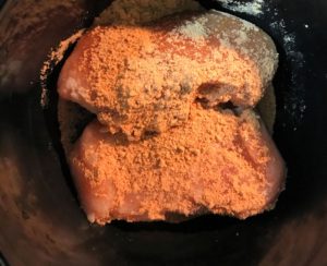 Sprinkle taco seasoning over the chicken breasts.