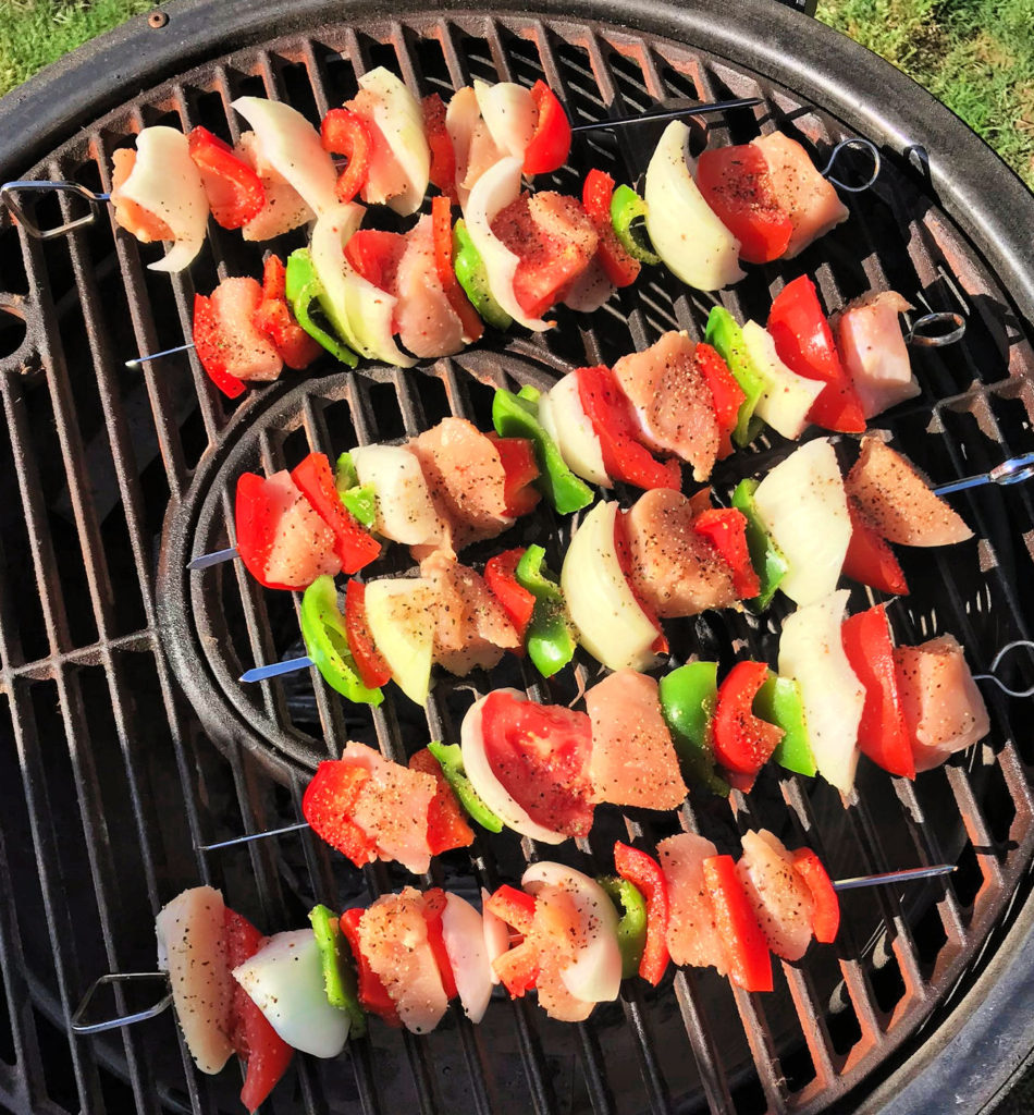 Cook chicken kabobs on the grill.