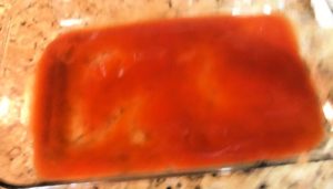 Spread red enchilada sauce over the bottom of the dish for beef enchiladas. 